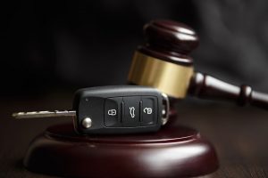 A gavel and a key fob, being used by an attorney focused on SMOG shops and auto repair shops.